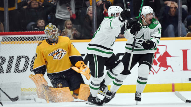 Dallas Stars center Craig Smith (15) and center Sam Steel (18) celebrate after defenseman Jani Hakanpaa (not pictured) scored the winning goal during the third period against the Nashville Predators at Bridgestone Arena. 